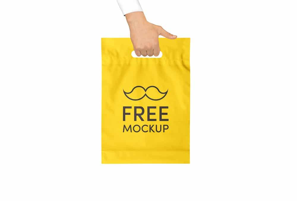 Hand holding Yellow Plastic Bag Free Mockup