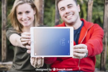 Couple Holding Tablet Mockup Freebie in PSD
