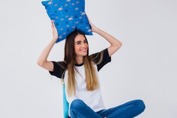 Free Woman Holding Chair Cushion Mockup in PSD