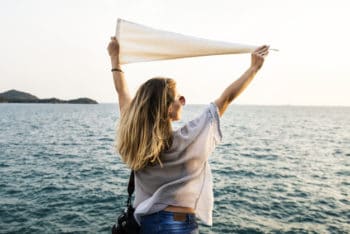 Free Woman Holding Flag Plus Sea Mockup in PSD